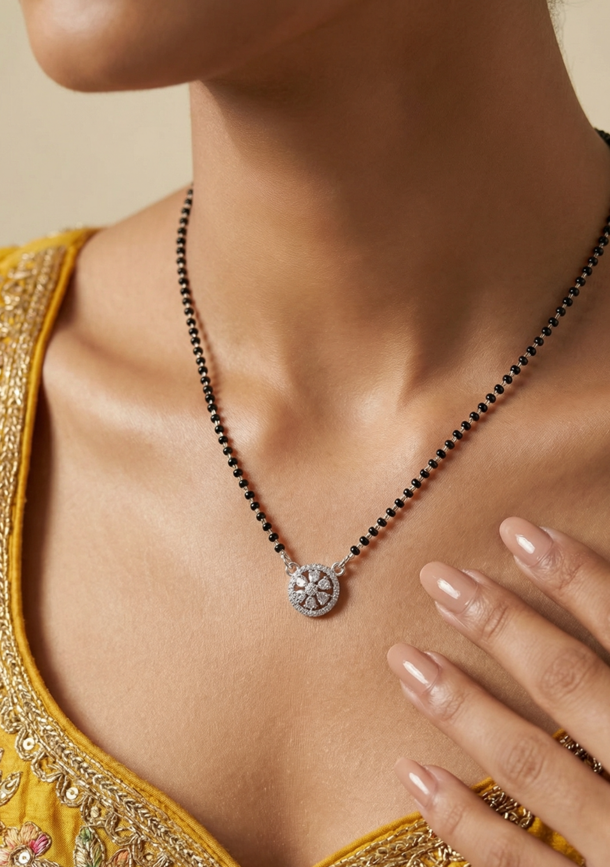 Necklace with a pendant worn by a person in a yellow outfit
